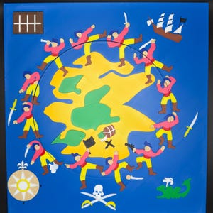 May include: A framed, colorful pirate-themed artwork. The artwork features a yellow island surrounded by a blue background. Around the island are cartoon pirates in pink shirts and yellow pants. A treasure chest, skull and crossbones, and a ship are also depicted.