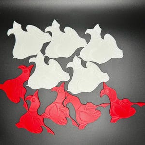 May include: A set of 10 3D printed bird shapes, 5 are white and 5 are red. The birds are all facing the same direction and have a similar design.