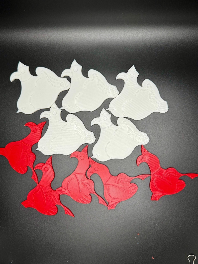 May include: A set of 10 3D printed bird shapes, 5 are white and 5 are red. The birds are all facing the same direction and have a similar design.