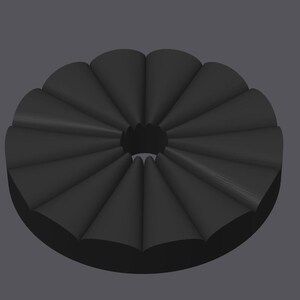 May include: A dark gray, circular object with a central hole. The object is composed of multiple, evenly spaced, cone-shaped segments, creating a radial pattern. The design has a three-dimensional appearance, with subtle shading to define the forms.