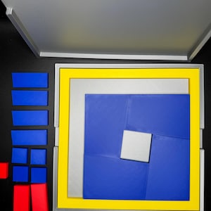May include: A blue and yellow puzzle box with a silver frame. The puzzle box is open and the puzzle pieces are arranged in a spiral pattern. The puzzle pieces are blue, yellow, and silver.
