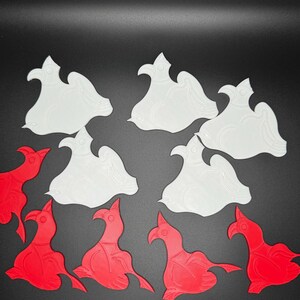 May include: A set of 10 white and red ceramic bird ornaments. The birds are in a variety of poses, with some facing forward and others facing sideways. The ornaments are all about 3 inches tall.