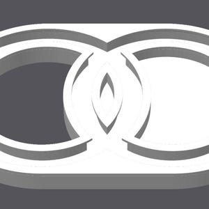 May include: A white, three-dimensional, geometric object featuring two interlocking circular rings set within a horizontal, pill-shaped frame. The design creates a central almond-shaped void where the two circular elements overlap.