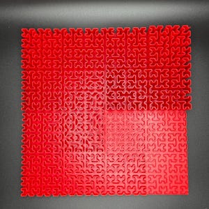 May include: A red interlocking puzzle made of plastic pieces. The puzzle is assembled in a square shape.