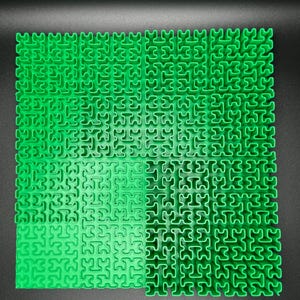 May include: A green puzzle mat with interlocking pieces in a grid pattern.