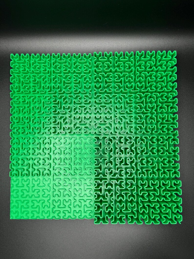 May include: A green puzzle mat with interlocking pieces in a grid pattern.