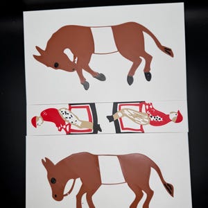 May include: Two brown donkey cutouts with white markings, one lying down and one standing.  A cutout of a person in a red and white jockey outfit is shown riding a donkey.