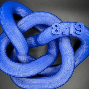 May include: A blue 3D printed knot with the numbers 8-19 printed on it.