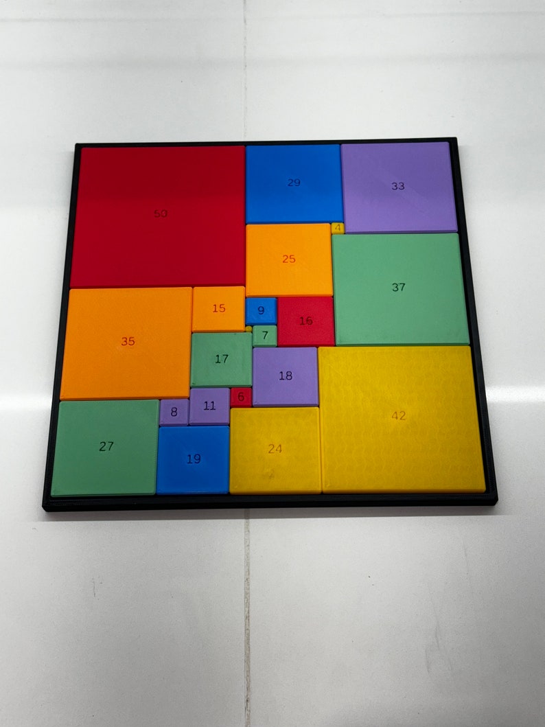 May include: A colorful square puzzle with numbers on each piece. The puzzle is made up of 16 squares, each with a different color and number. The colors include red, orange, yellow, green, blue, purple, and brown.