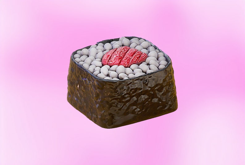 May include: A single sushi roll with a red fish topping and white rice wrapped in seaweed.
