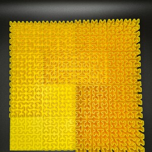 May include: A yellow interlocking puzzle mat made of plastic. The mat is made up of small squares that fit together to create a larger surface.