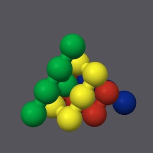 May include: A three-dimensional pyramid structure composed of interconnected spheres in vibrant colors including green, yellow, red, and blue. The spheres are arranged in a triangular formation, creating a geometric shape with a smooth surface finish.