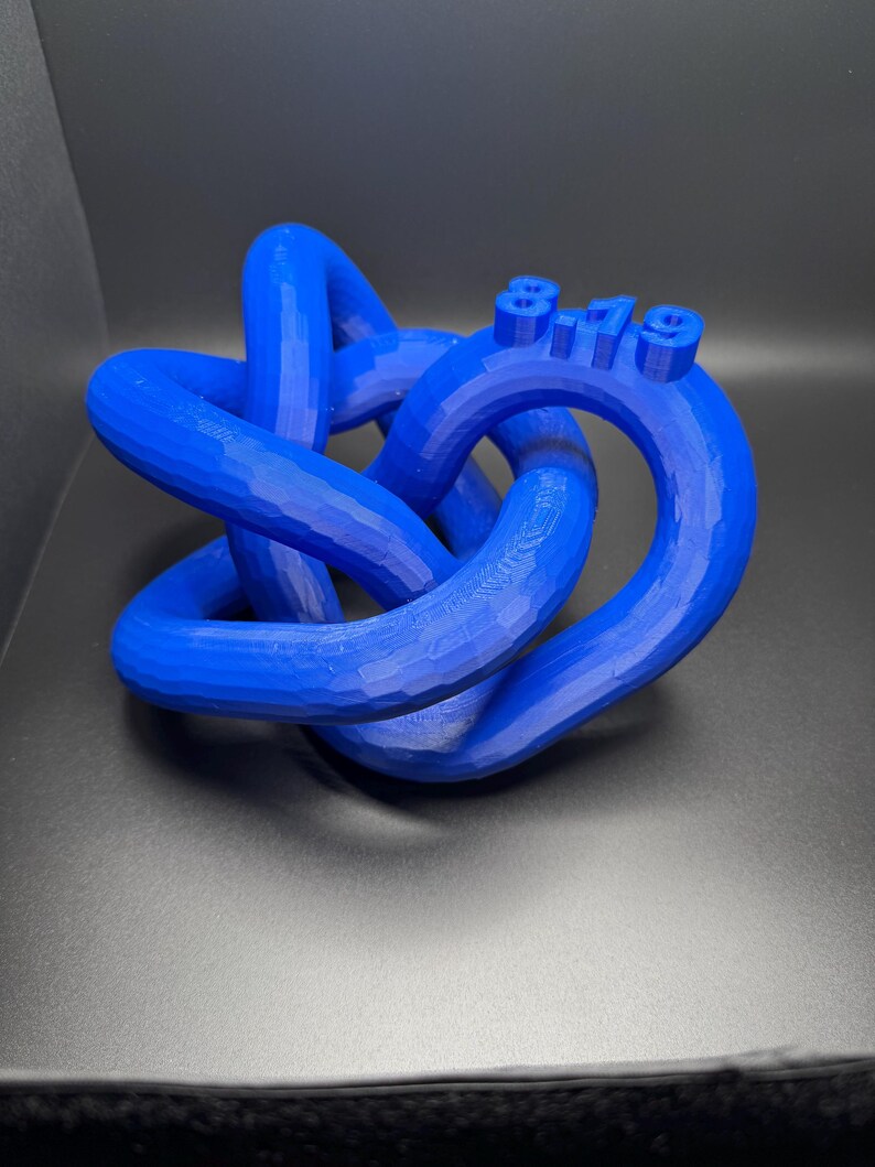 May include: A blue 3D printed knot sculpture with the date "8.19" printed on it.