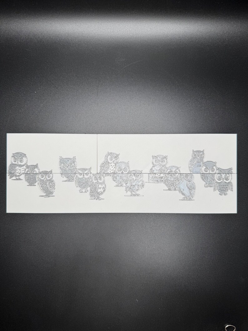 May include: A sheet of white paper with multiple black and white owl illustrations. The owls are in various poses and sizes.