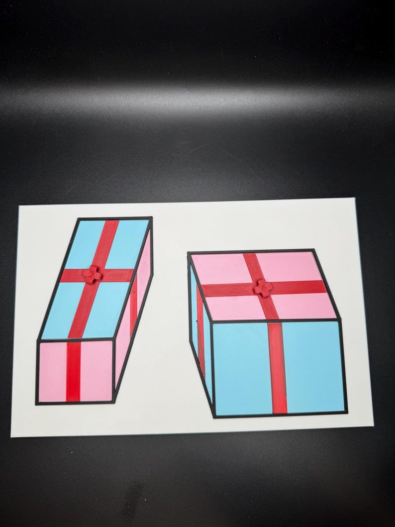May include: Two colorful gift boxes are depicted on a white background. One box is pink with a blue top and red ribbon, while the other is blue with a pink top and red ribbon. Both have black outlines.