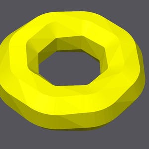 May include: A bright yellow geometric donut shape with a hexagonal hole in the center.
