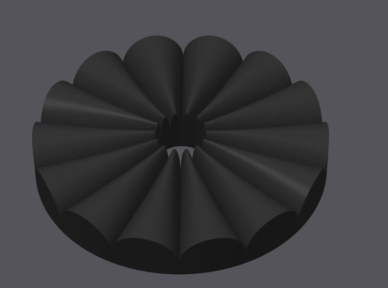 May include: A black, circular object with a series of cone-shaped elements arranged around a central opening. The object has a matte finish and is set against a gray background. The design is symmetrical and geometric.