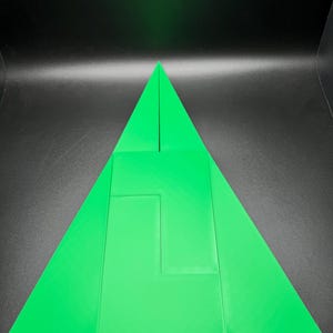 May include: A green triangle puzzle made of five pieces. The pieces fit together to form a larger triangle.