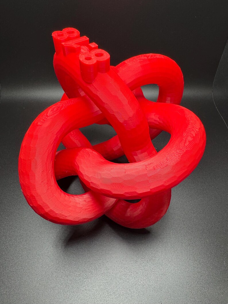 May include: A red 3D printed knot sculpture with the number "88" printed on the top.