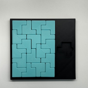 May include: A blue and black puzzle game with a variety of differently shaped pieces that fit together to form a larger shape. The puzzle is made of plastic and has a textured surface.