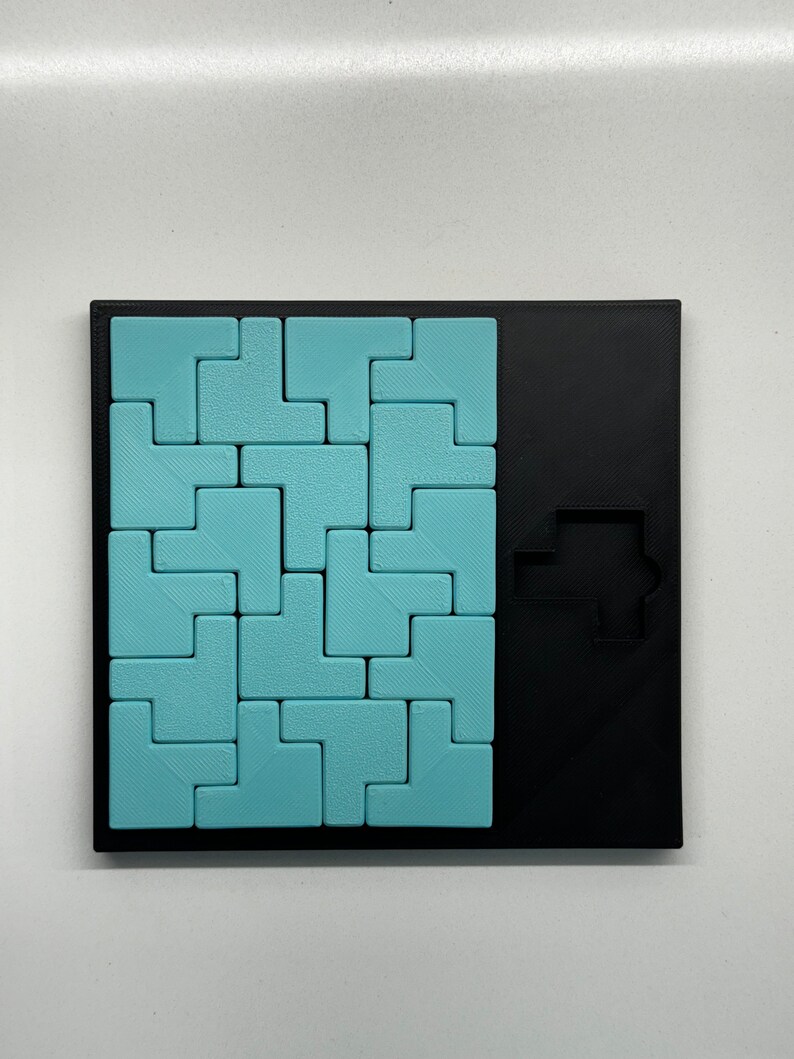 May include: A blue and black puzzle game with a variety of differently shaped pieces that fit together to form a larger shape. The puzzle is made of plastic and has a textured surface.