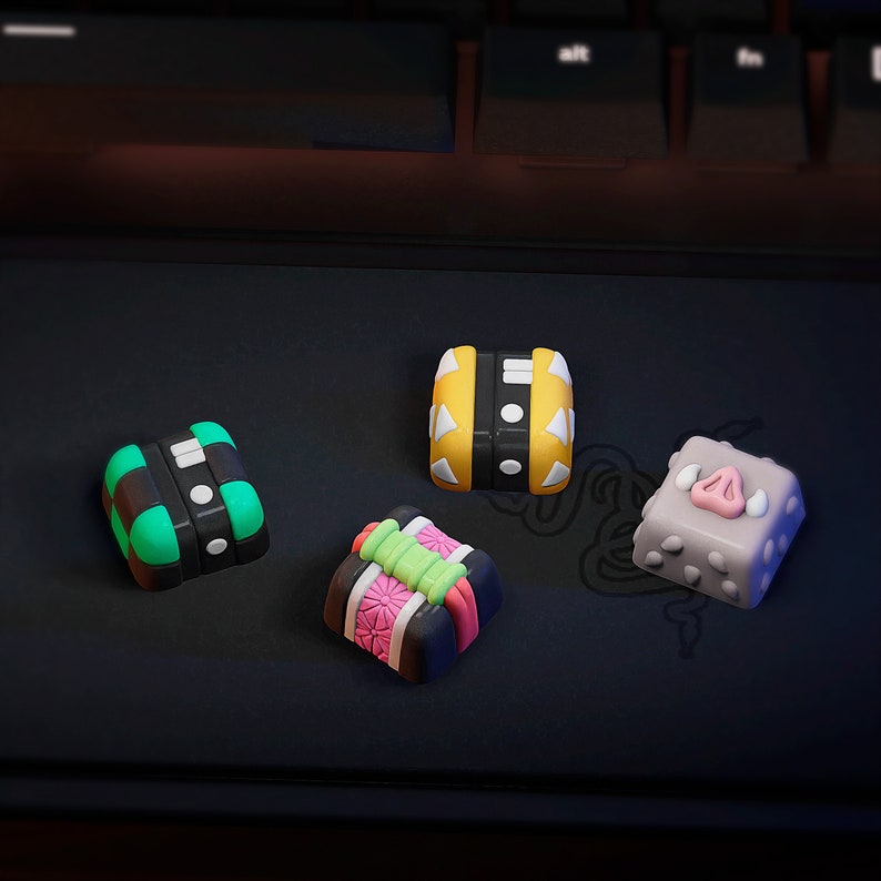 May include: Four colorful keycaps with different designs. The keycaps are made of plastic and have a glossy finish. The keycaps are arranged in a row on a black surface. The keycaps are all different shapes and sizes. The keycaps are all different colors. The keycaps are all different designs.