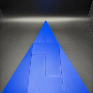 May include: A blue triangle puzzle with a unique interlocking design. The puzzle is made of multiple pieces that fit together to form a larger triangle.