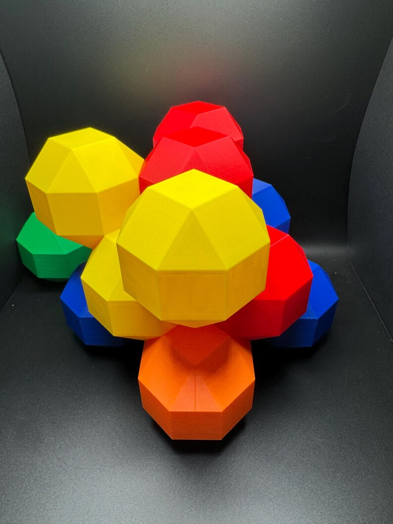 May include: A group of colorful geometric shapes, stacked on top of each other. The shapes are red, yellow, orange, green, and blue.