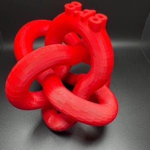 May include: A red 3D printed knot sculpture with the numbers "88-188" printed on the top.