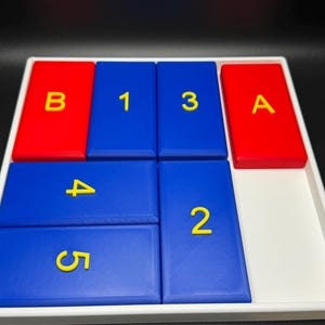 May include: A white tray with blue and red tiles. The blue tiles have the numbers 1, 3, 4, 5, and 2 printed on them in yellow. The red tiles have the letters B and A printed on them in yellow.