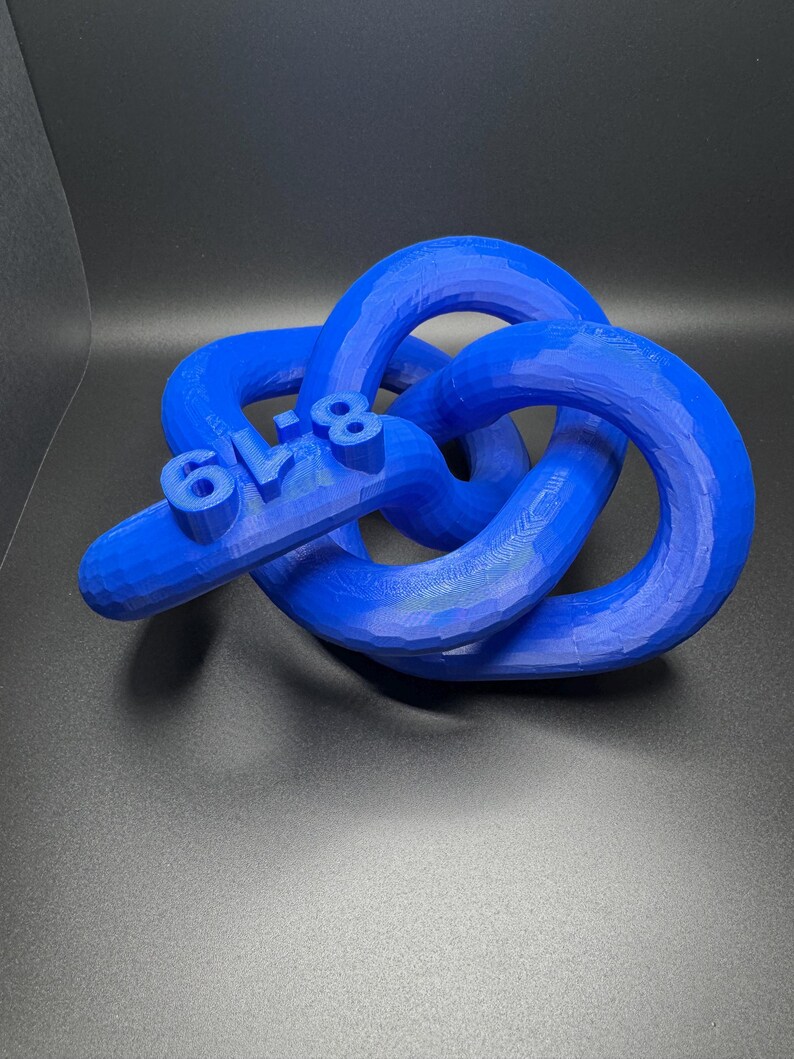 May include: A blue 3D printed knot sculpture with the number "618" printed on it.