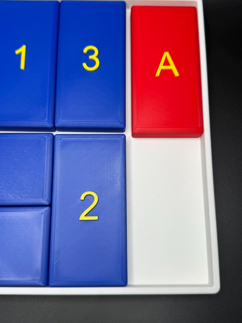 May include: A white tray with blue and red tiles. The blue tiles have the numbers 1, 2, and 3 printed in yellow. The red tile has the letter A printed in yellow.