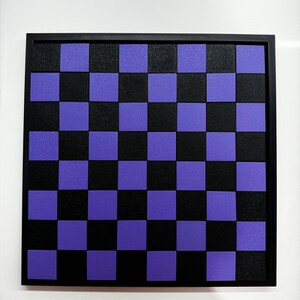 May include: A black and purple checkerboard game board with a black frame.