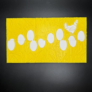 May include: A yellow puzzle with a white chicken and eggs. The puzzle is made of multiple pieces that fit together to form a complete image.