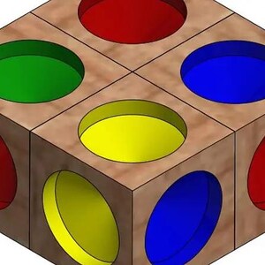 May include: A wooden cube with circular openings on each face, painted in red, green, blue, and yellow. The cube has a light brown wood grain finish. The design is a geometric shape.