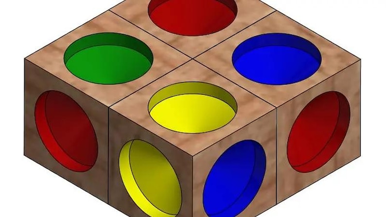 May include: A wooden cube with circular openings on each face, painted in red, green, blue, and yellow. The cube has a light brown wood grain finish. The design is a geometric shape.