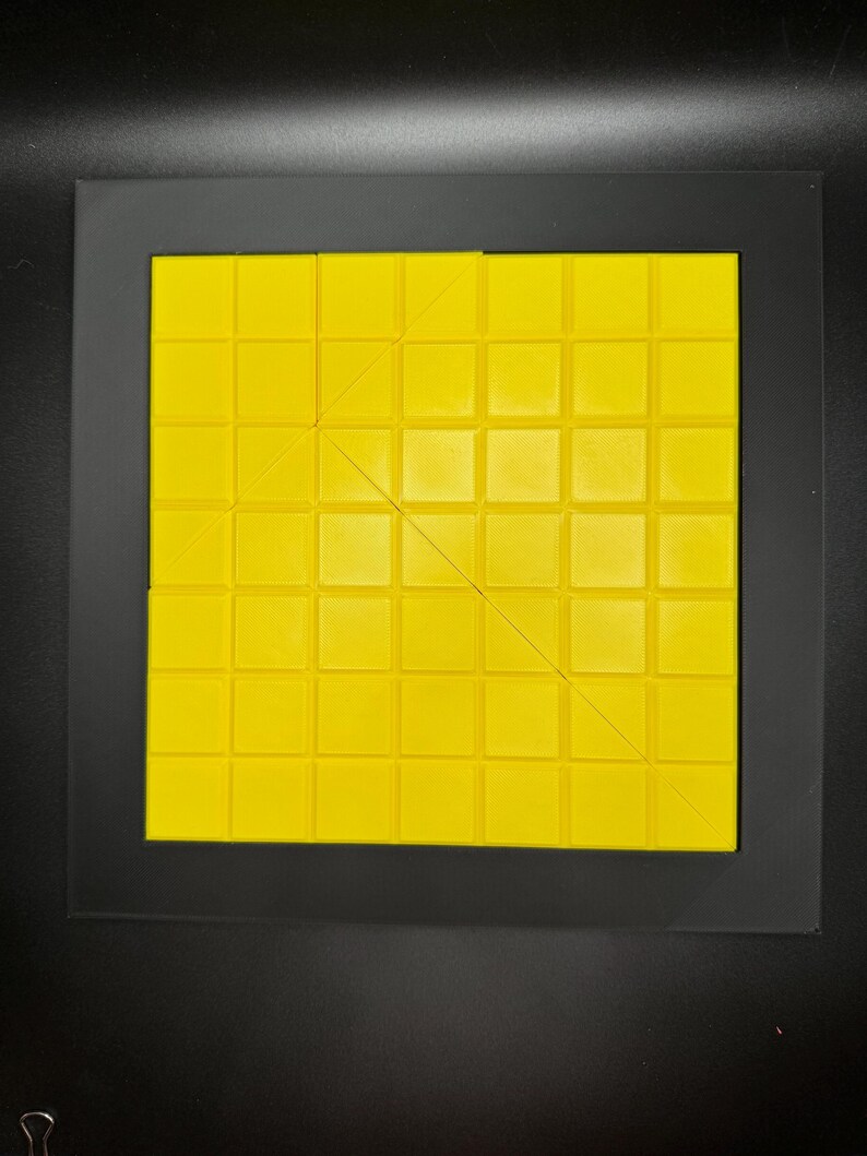 K&ouml;nnte beinhalten: Ein gelbes quadratisches Puzzle aus kleineren Quadraten. Das Puzzle ist durch diagonale Linien in drei Abschnitte unterteilt.