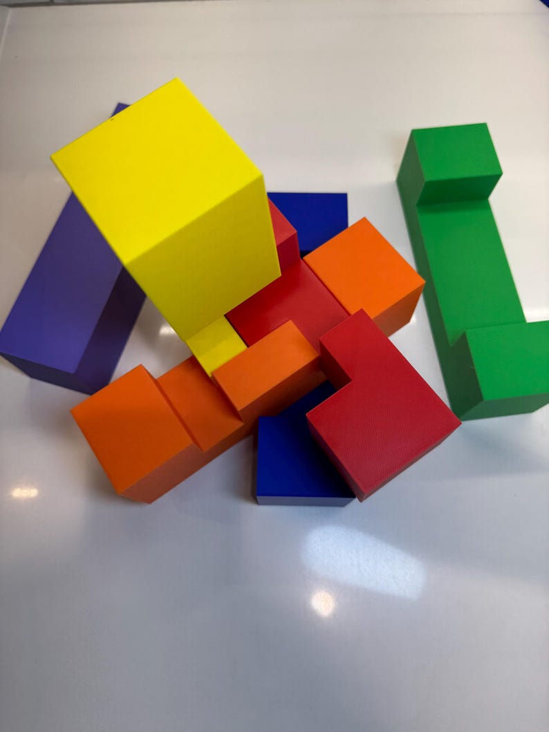 May include: A colorful wooden puzzle with blocks in red, orange, yellow, blue, green, and purple. The blocks are arranged in a complex pattern, creating a challenging puzzle.