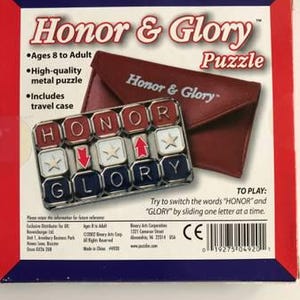 May include: A boxed "Honor & Glory" puzzle with a red, white, and blue color scheme. The puzzle includes a metal puzzle and a travel case. The puzzle's objective is to switch the words "HONOR" and "GLORY" by sliding one letter at a time.