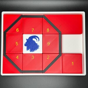 May include: A red and black puzzle with a goat silhouette in the center. The puzzle pieces are numbered 1 through 9.