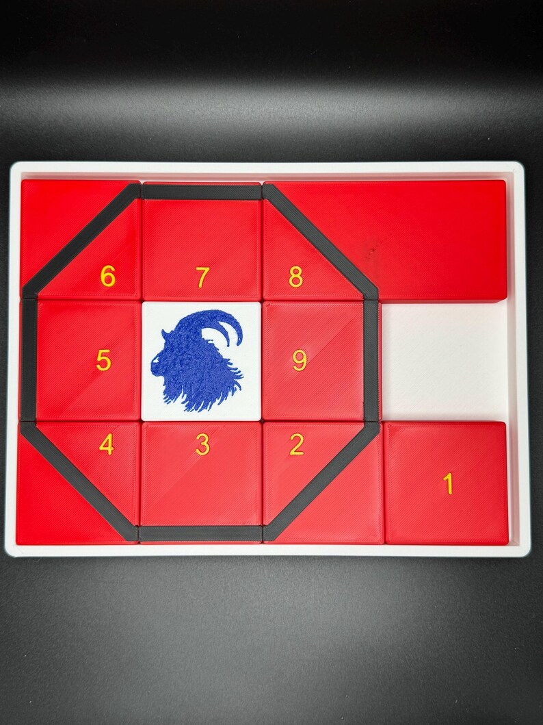 May include: A red and black puzzle with a goat silhouette in the center. The puzzle pieces are numbered 1 through 9.