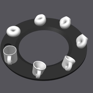 Op de afbeelding: Een donkergrijs cirkelvormig object met een centrale opening, met zes witte donuts en drie witte mokken rondom de omtrek. De donuts zijn gelijkmatig verdeeld en de mokken zijn met tussenpozen geplaatst.