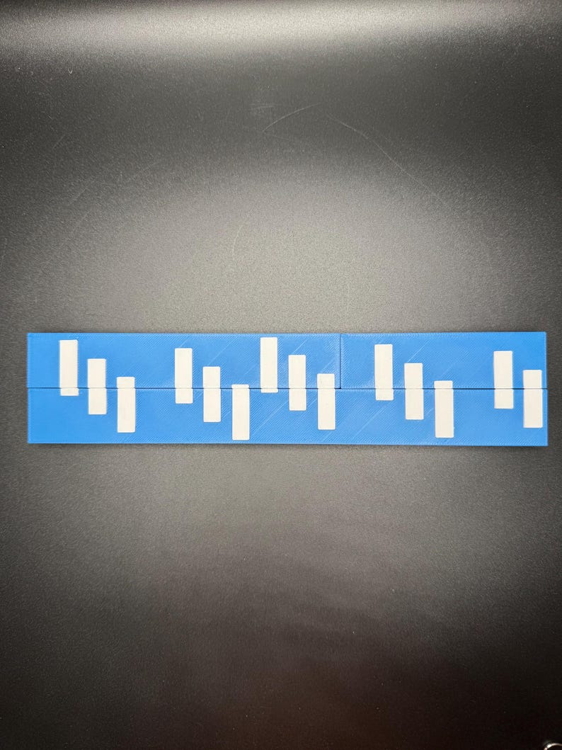 May include: A blue ruler with white markings. The ruler is divided into sections with white lines.