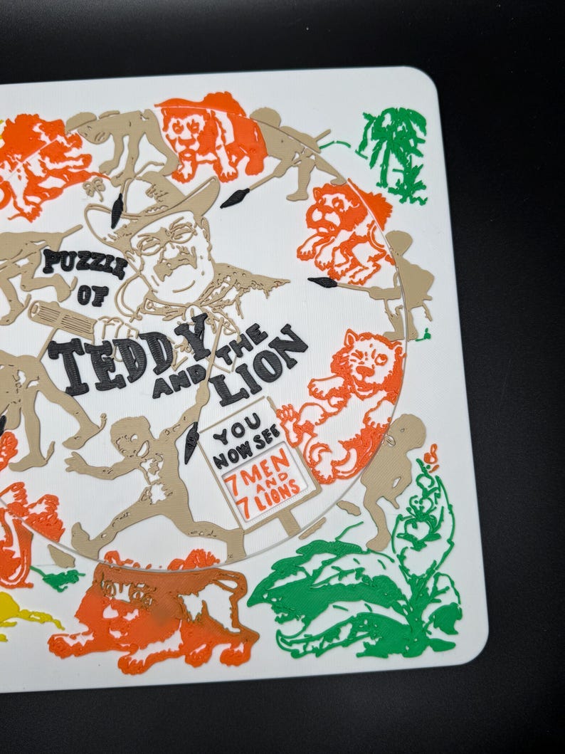 May include: A white puzzle featuring a circular design with the text "Puzzle of Teddy and the Lion." The design includes illustrations of lions, men, and foliage in orange, green, and tan colors. The text "You Now See 7 Men and 7 Lions" is also present.