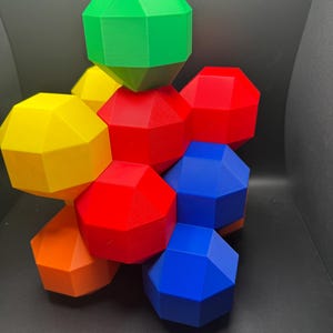 May include: A geometric puzzle made of six colorful, multi-faceted pieces. The pieces are red, yellow, green, blue, and orange.