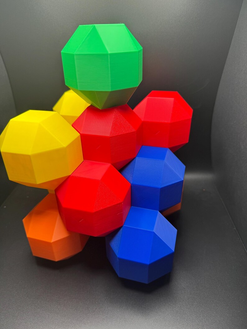 May include: A geometric puzzle made of six colorful, multi-faceted pieces. The pieces are red, yellow, green, blue, and orange.