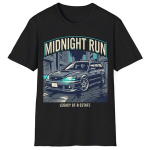 May include: Black t-shirt with a graphic of a dark grey car with teal headlights and the text "MIDNIGHT RUN" above and "LEGACY GT-B ESTATE" below. The car is set in a city scene.