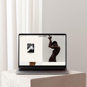 May include: A silver laptop displaying a website with the text Carla Adams at the top. The screen features a black and white photograph of a person in a dress and a separate image of a person posing with arms raised above their head.