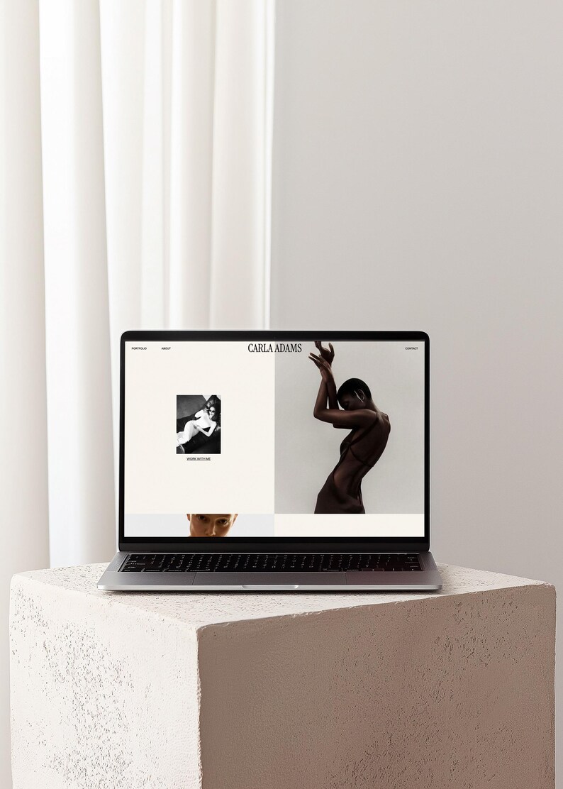 May include: A silver laptop displaying a website with the text Carla Adams at the top. The screen features a black and white photograph of a person in a dress and a separate image of a person posing with arms raised above their head.