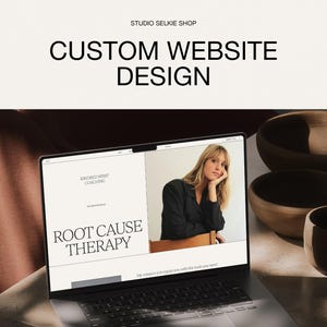 May include: A laptop screen displaying a website design with the text STUDIO SELKIE SHOP and CUSTOM WEBSITE DESIGN at the top. The webpage features the text KINDRED SPIRIT COACHING and ROOT CAUSE THERAPY alongside a photograph of a person.
